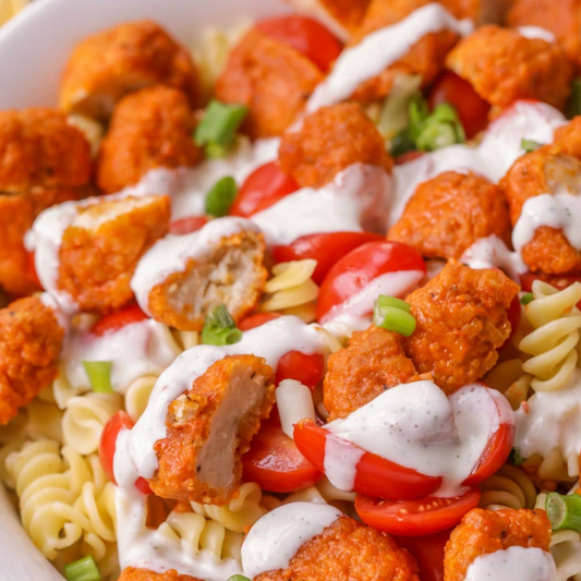 Buffalo Vegan Chicken Poppers over Garlic Bechamel Rotini Pasta (Contains Gluten)